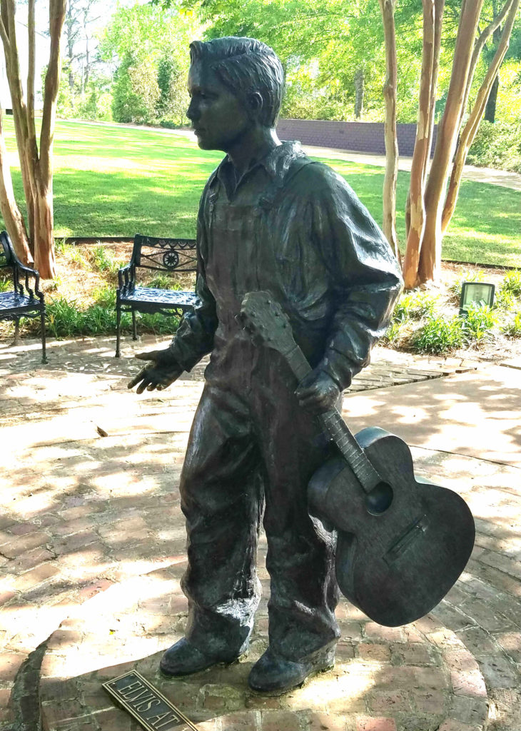 Statue of young Elvis Presley at the Elvis Presley Birthplace Visitor Center. Elvis began singing specials at the First Assembly of God church at age 9. Mississippi triathlon run passed this house.