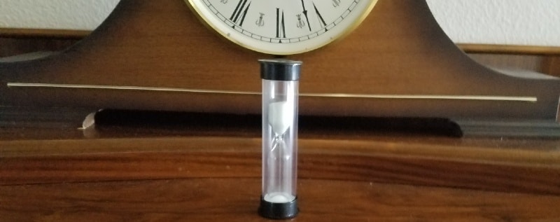 hourglass & clock image to symbolize impatience in triathlon training