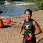 jogging to the transition area after an open water triathlon swim