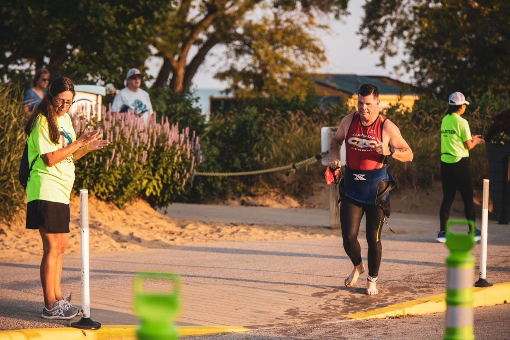 Masters triathlete jogging from the swim exit to transition at the 2024 Pan-American Masters Games, part of the World Masters Games