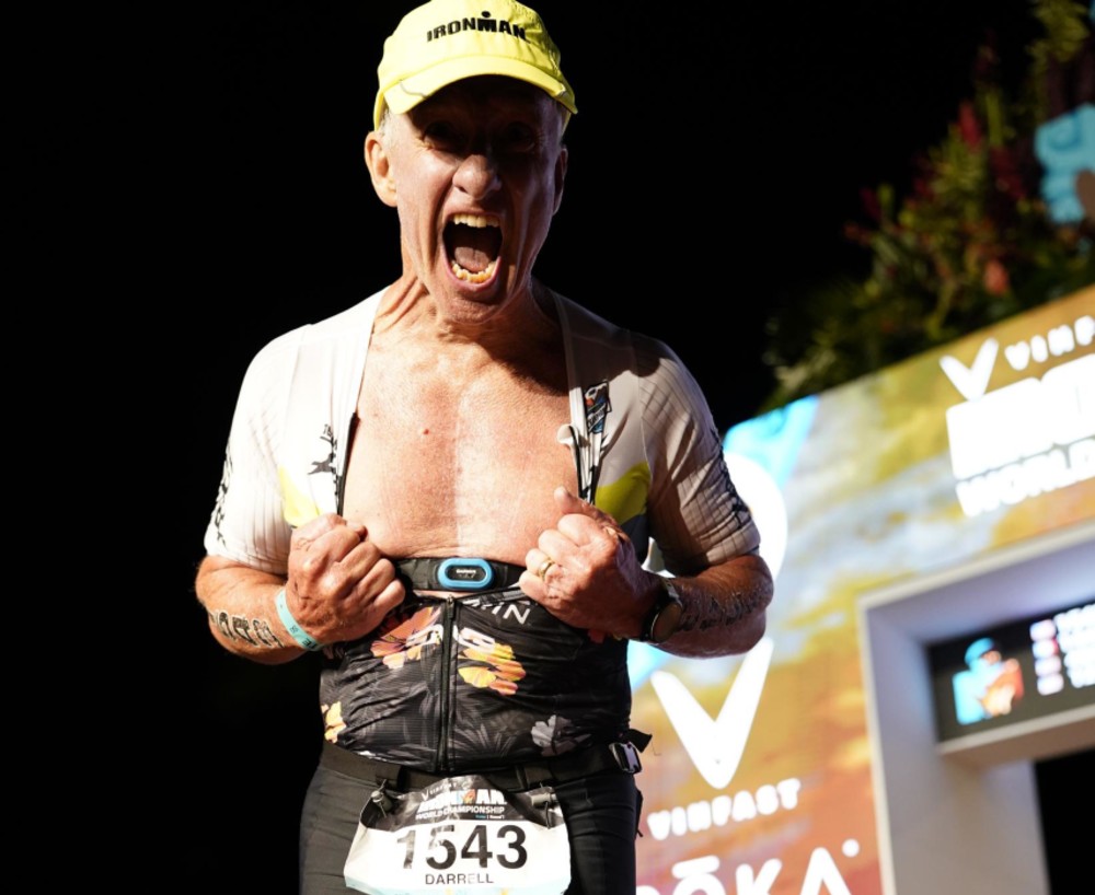 Darrell Myrick at the 2022 Ironman Championship finish line revealing his scar from open heart surgery within the last year