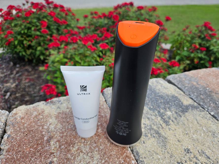 Ultriix S1 ultrasonic massager beside a tube of conductive gel